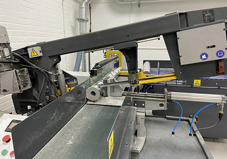 An image displaying a large cutting machine, part of the manufacturing of Phenolic Insulation Blocks.